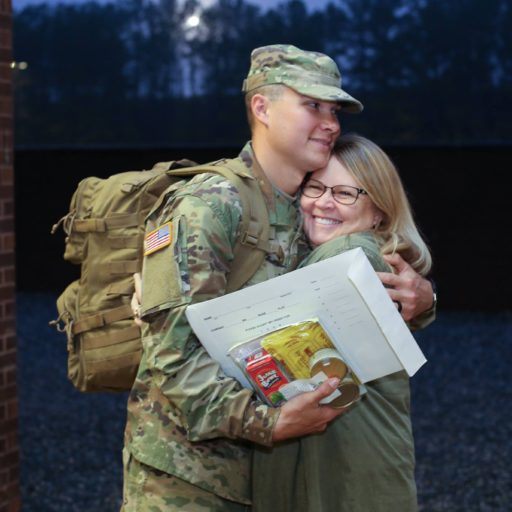 mom and her solder son hugging after graduation at fort benning gearogia